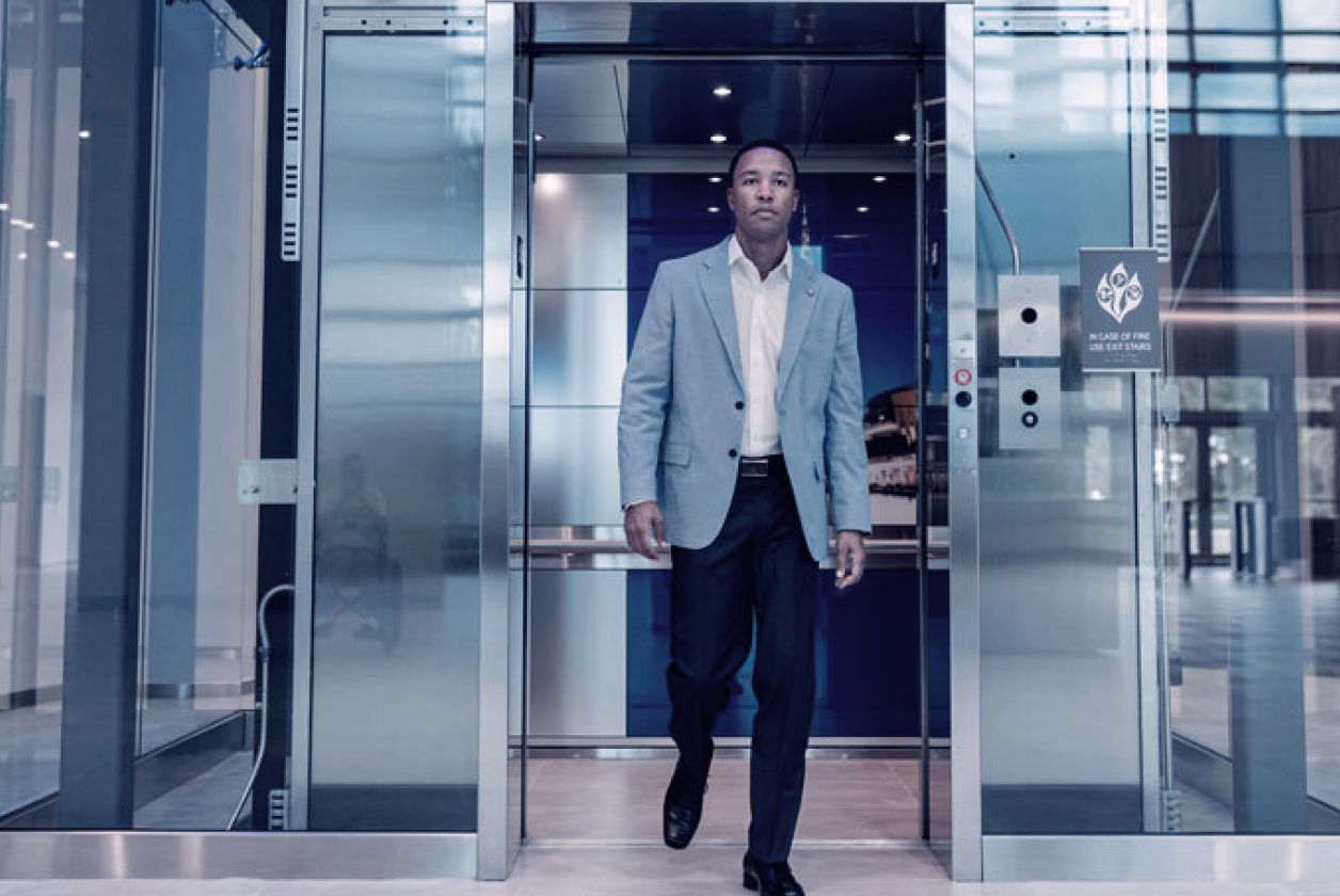 a man going out of an elevator automatic doors